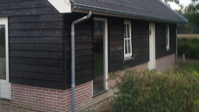 Binnenzijde van het tuinhuis met houten balken en zolder in tuinhuis in Epe